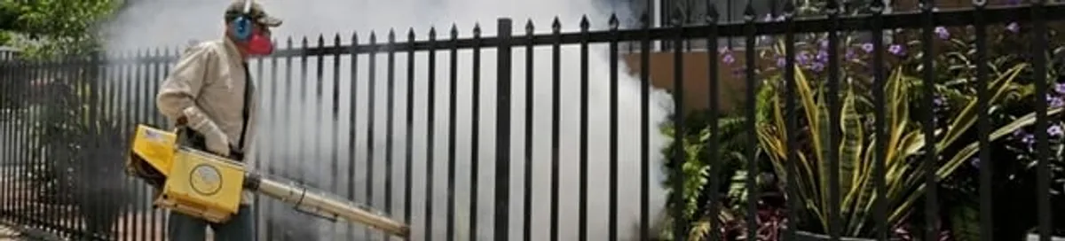 Mosquito control technician fogging a yard perimeter for mosquito reduction in Philadelphia, PA